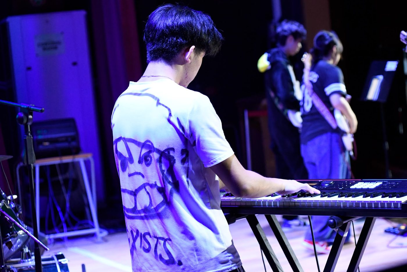 White tee sprayed by hand with the MOGI face and EXISTS