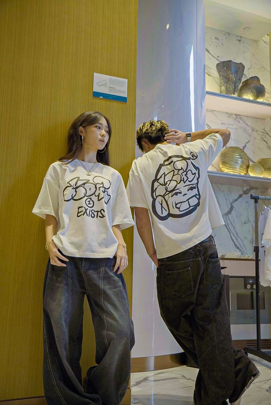 Two people in Drop 0 tees, front and back print