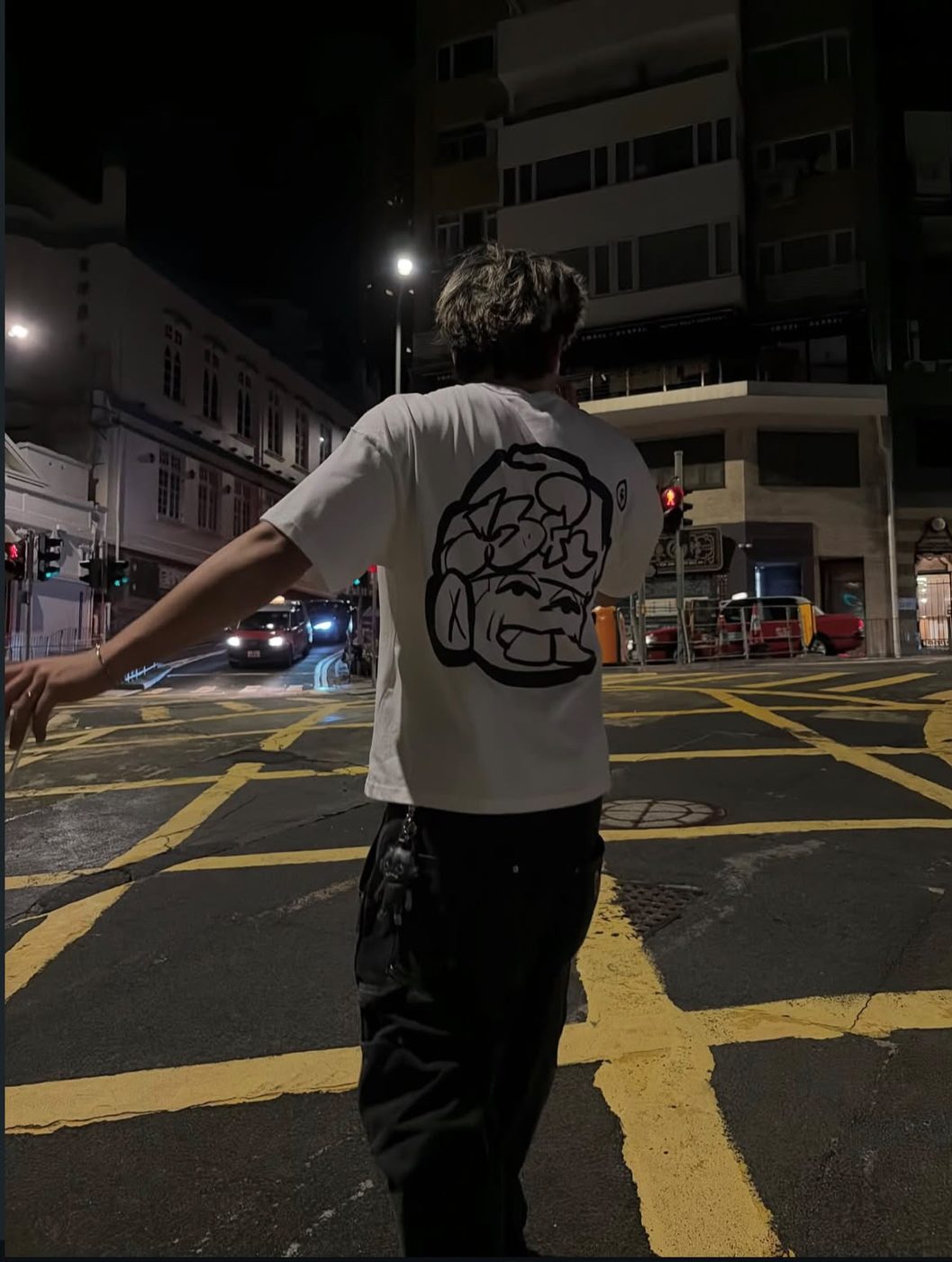 Drop 0 tee worn on a Hong Kong street at night, back print